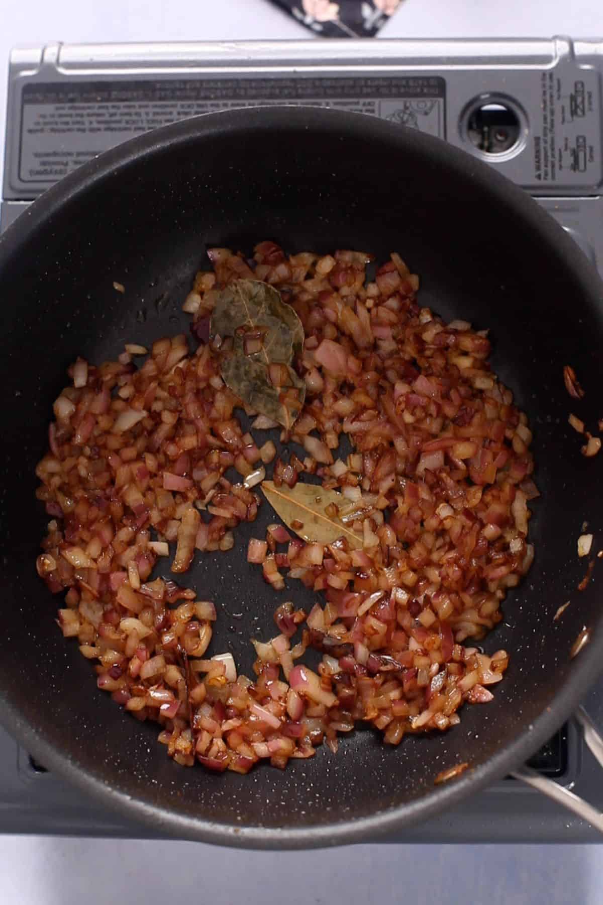 Browned onions in a cooking pot.
