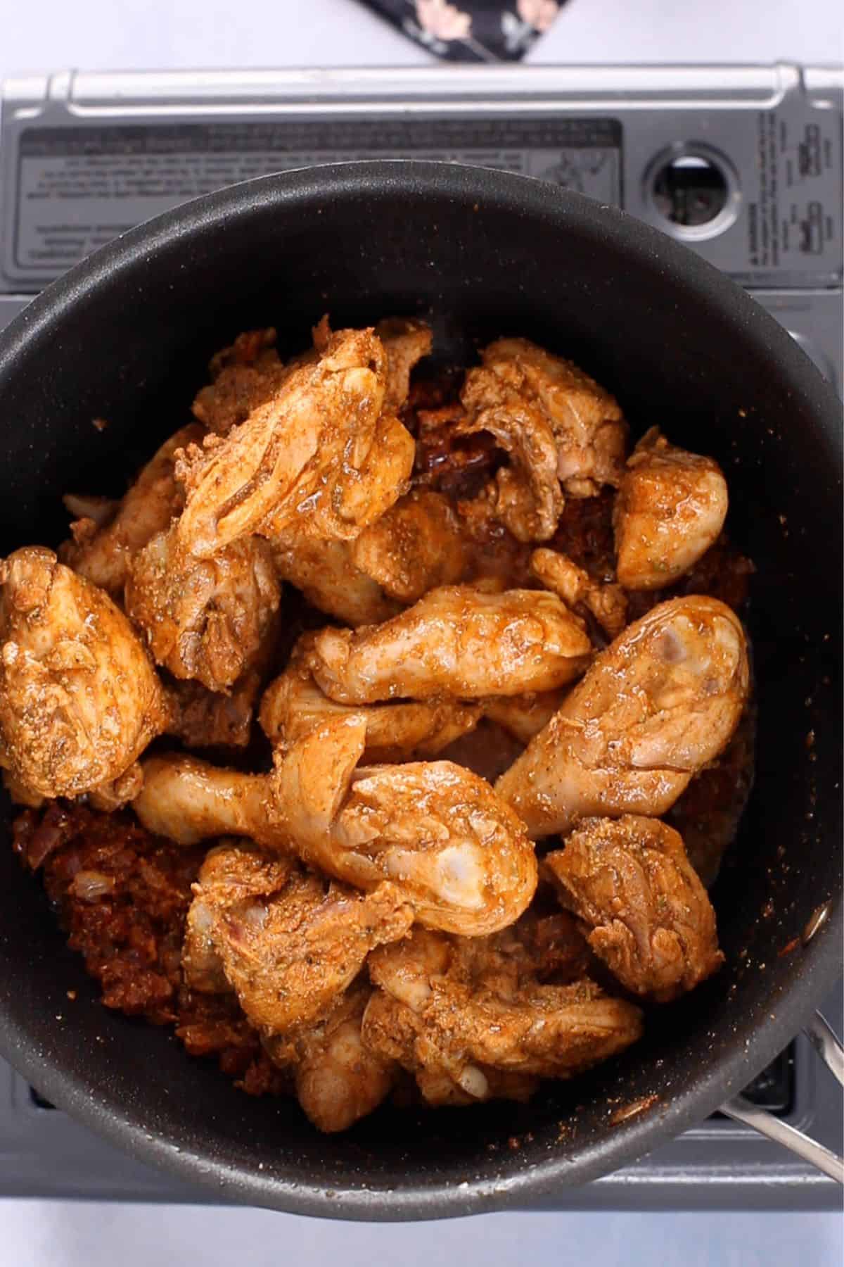 Seared chicken is added to the masala. 