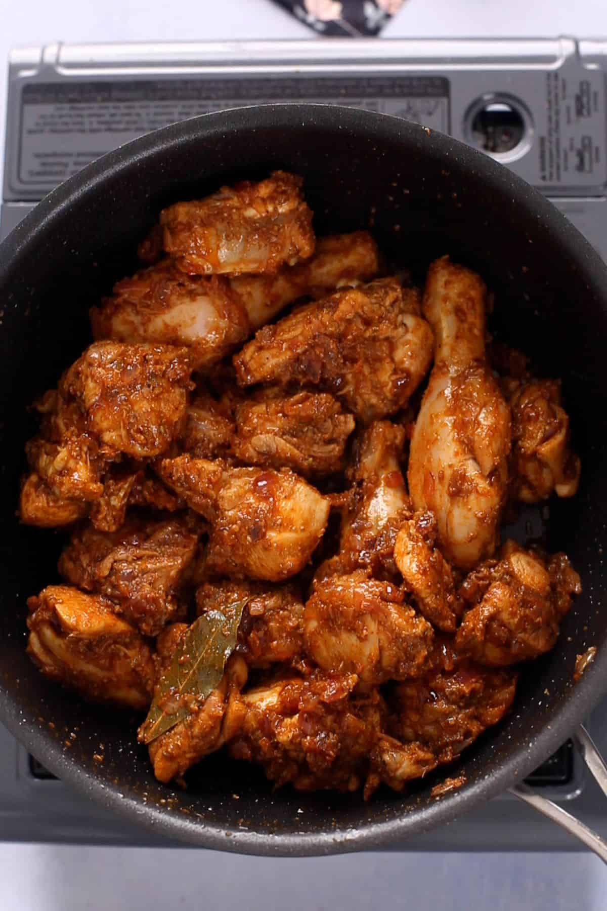 Chicken is stir fried with masala.