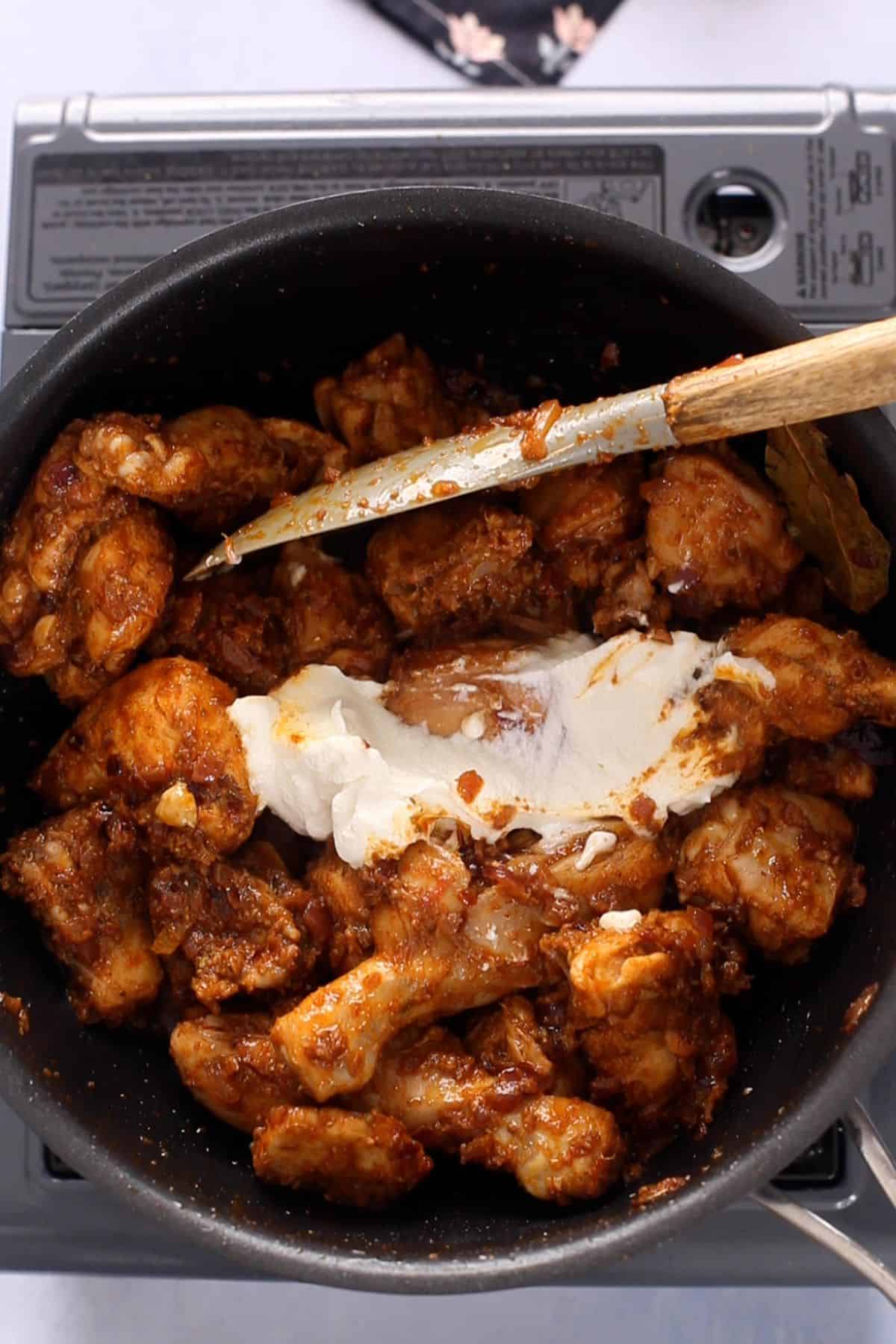 Yogurt is added to the cooking pot.