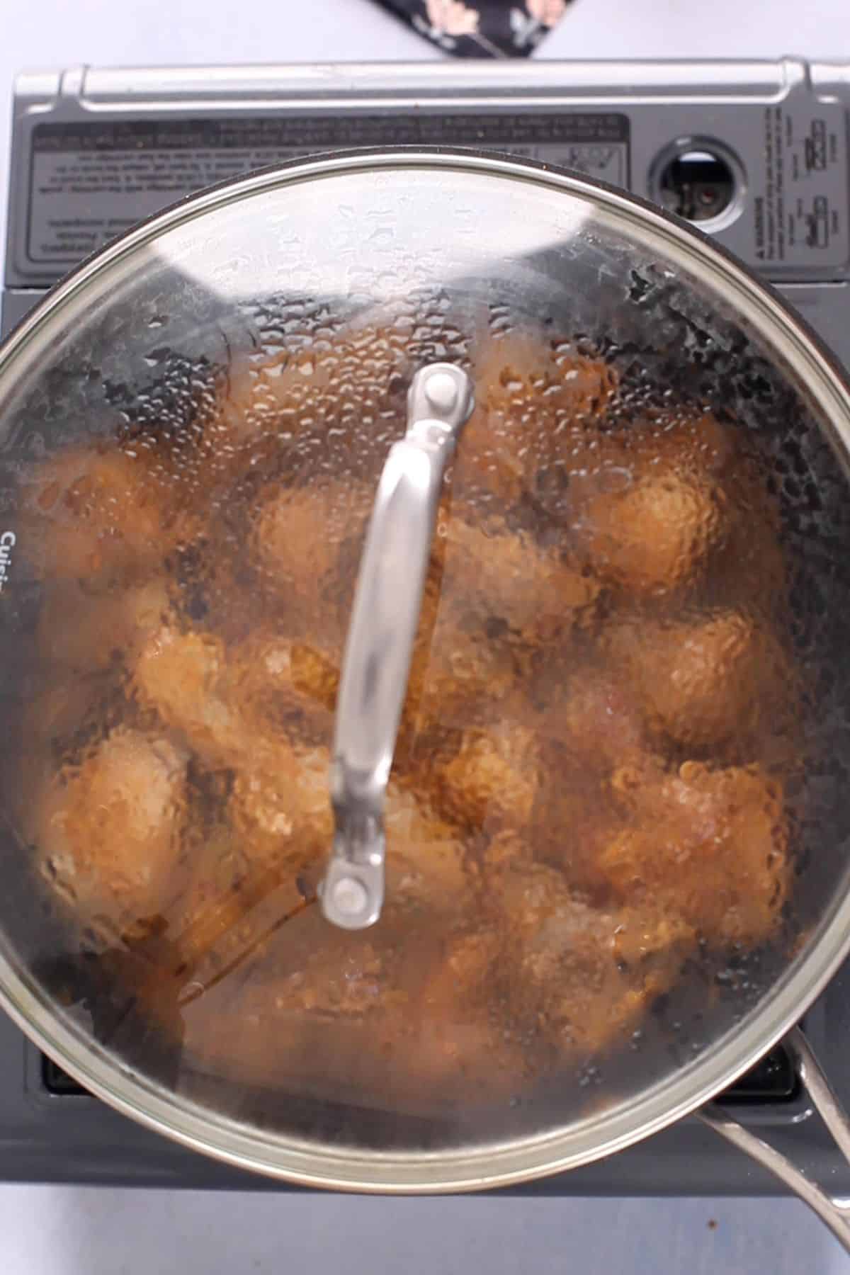 Cooking pot is covered to let the chicken cook.