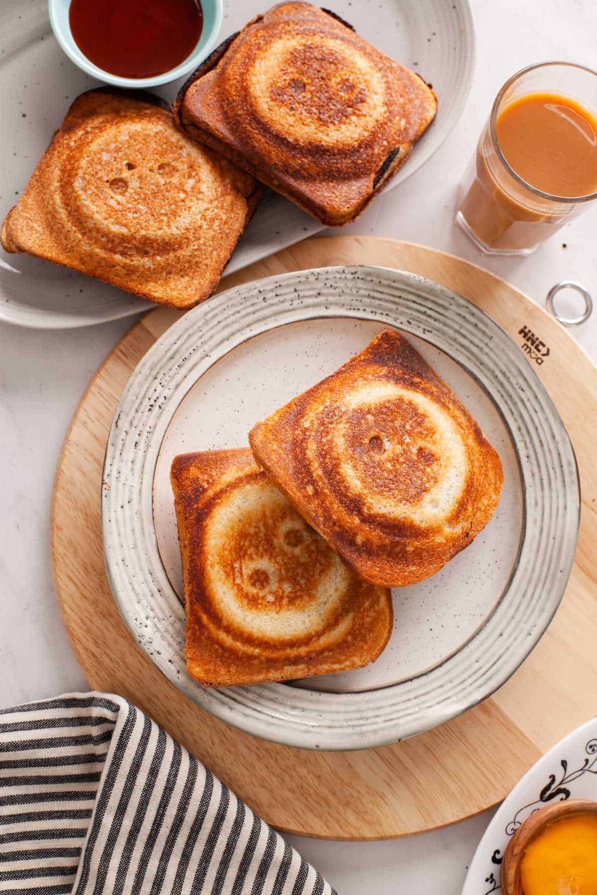 Mashed potato sandwiches on a beige ceramic plate.
