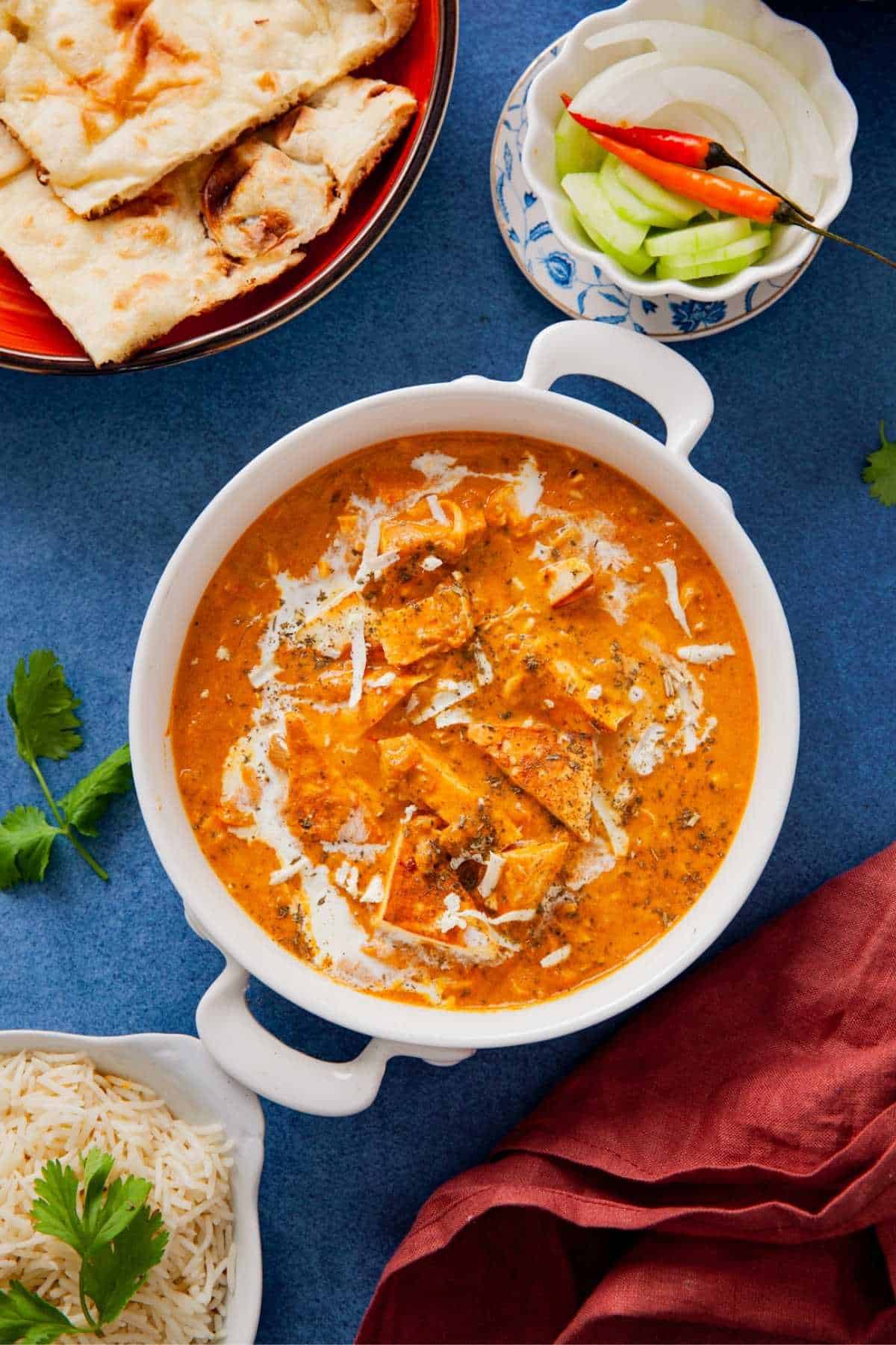 Close up of creamy paneer lababdar curry in a white dish.