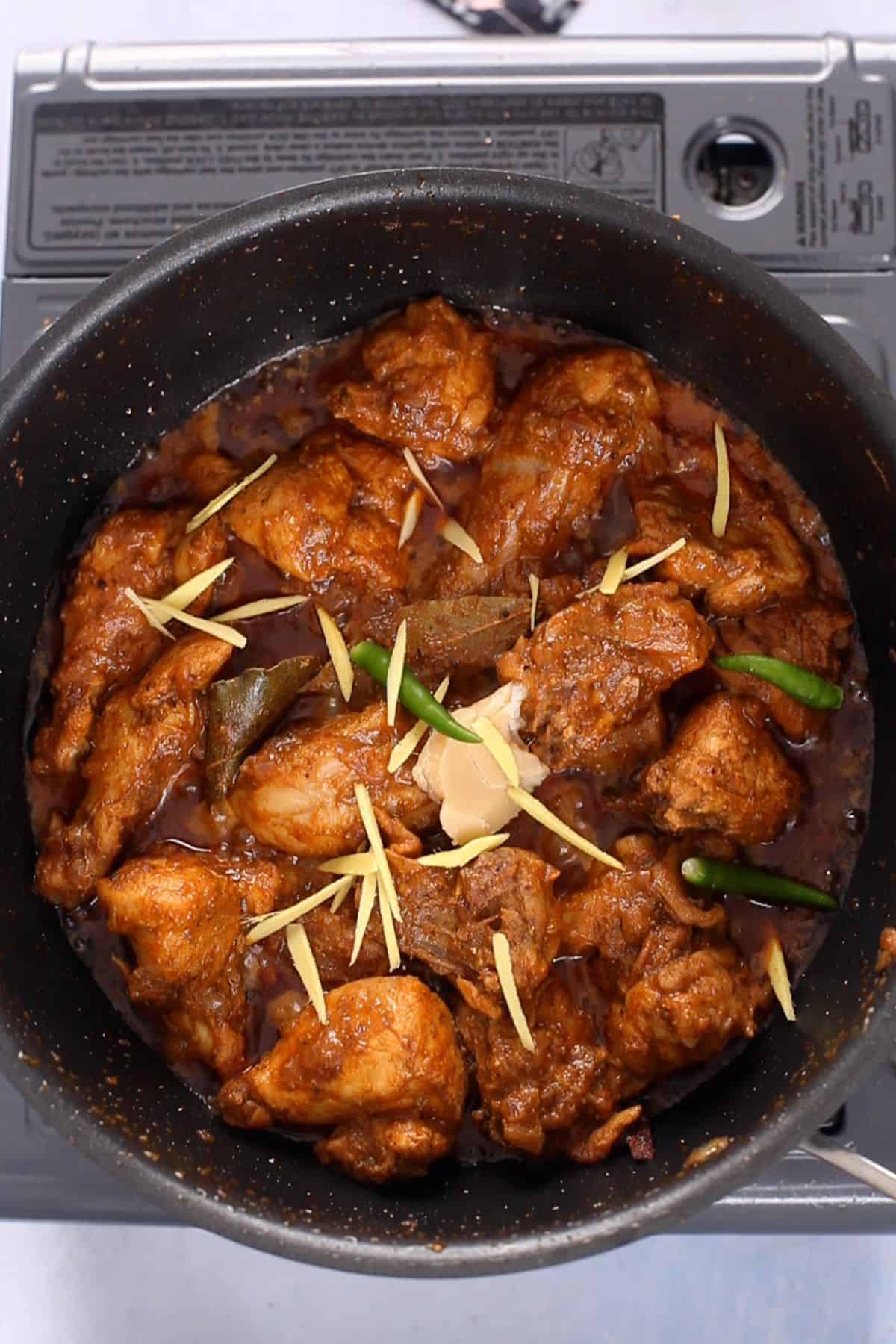 Chicken bhuna is finished with ginger and green chilies. 