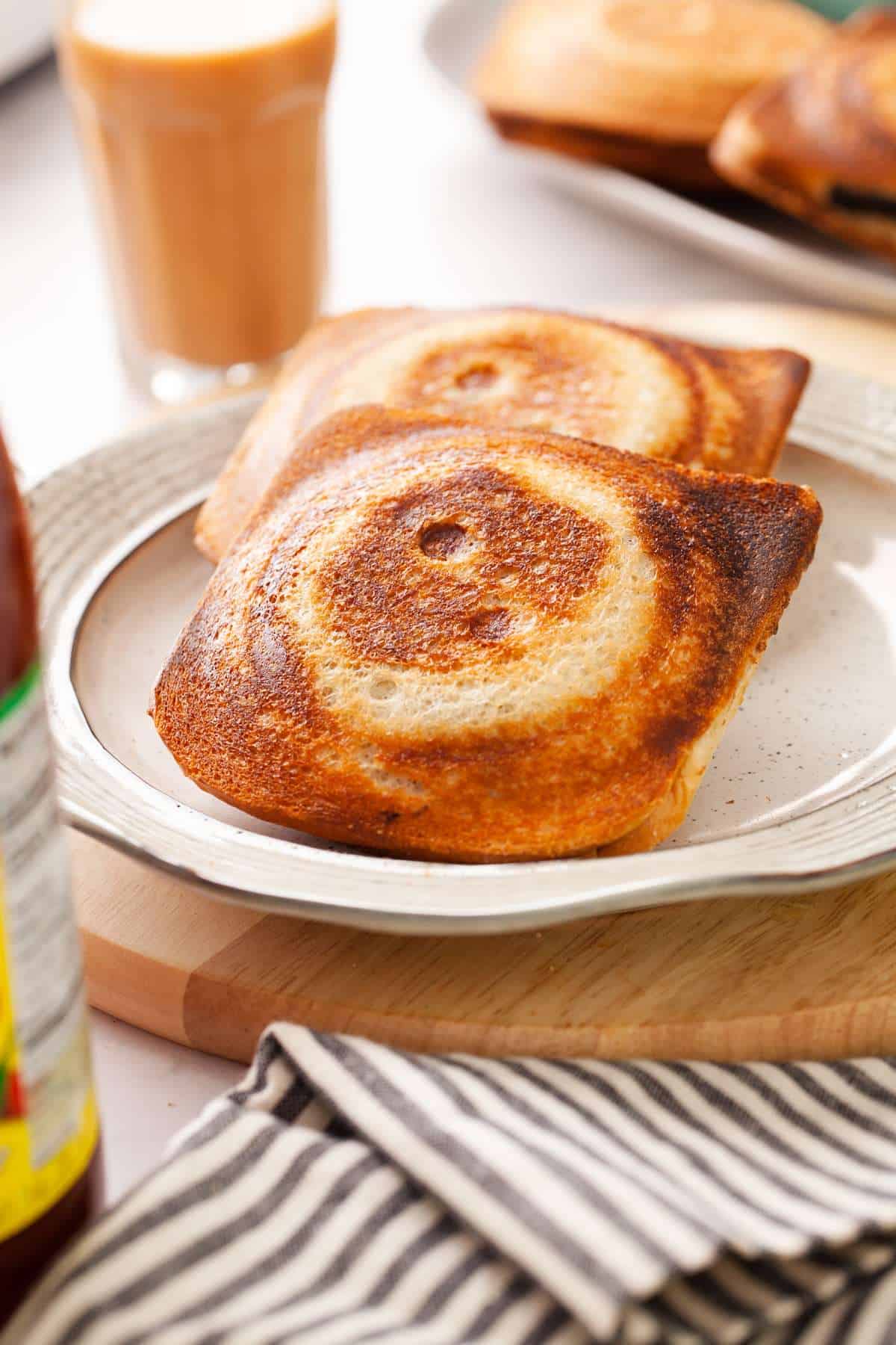 Close up side view of the crisp aloo masala sandwiches.