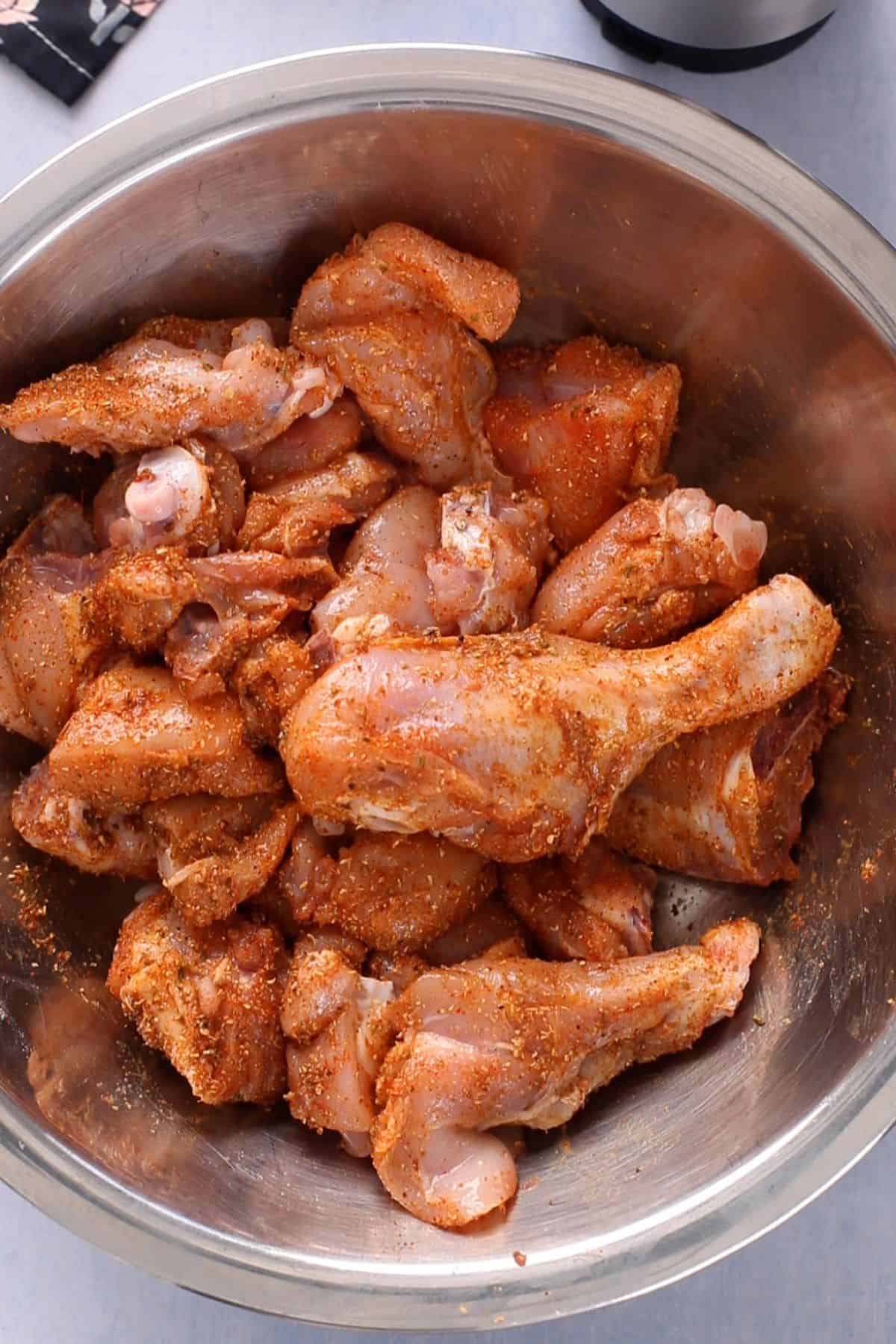 Chicken is coated in spices and salt.