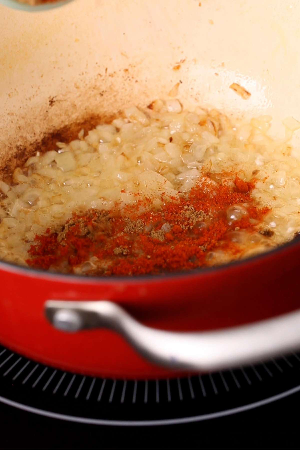 Add powdered spices to onions.