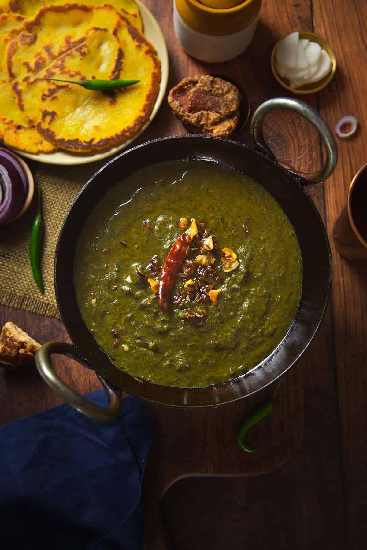Sarson Ka Saag Served with Makki di Roti, jaggery & onion.