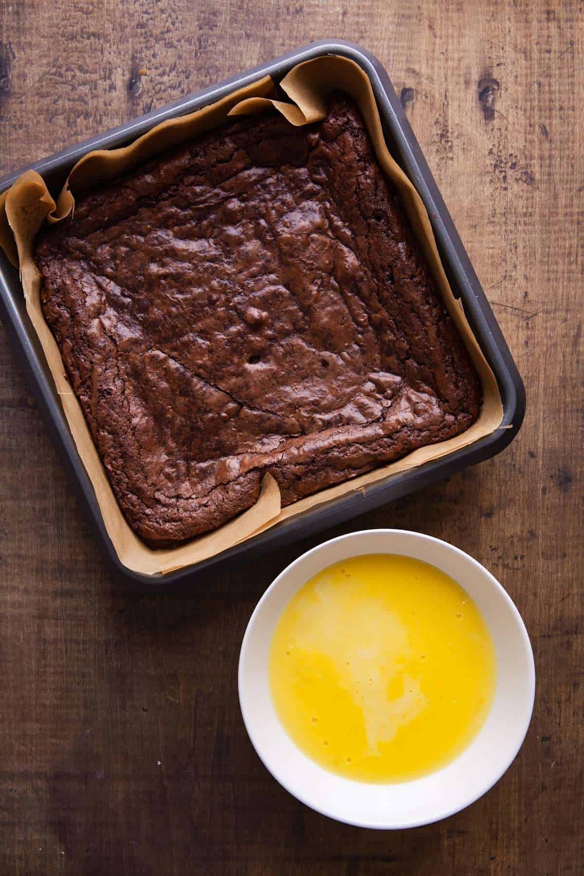 Baked Brownies and Vanilla Custard in a white bowl. 