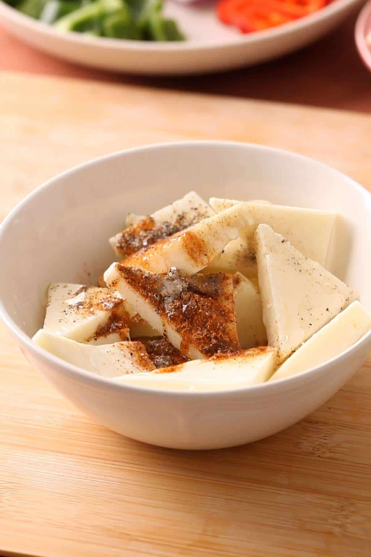 Marinating Paneer in spices, ginger garlic, vinegar & oil.