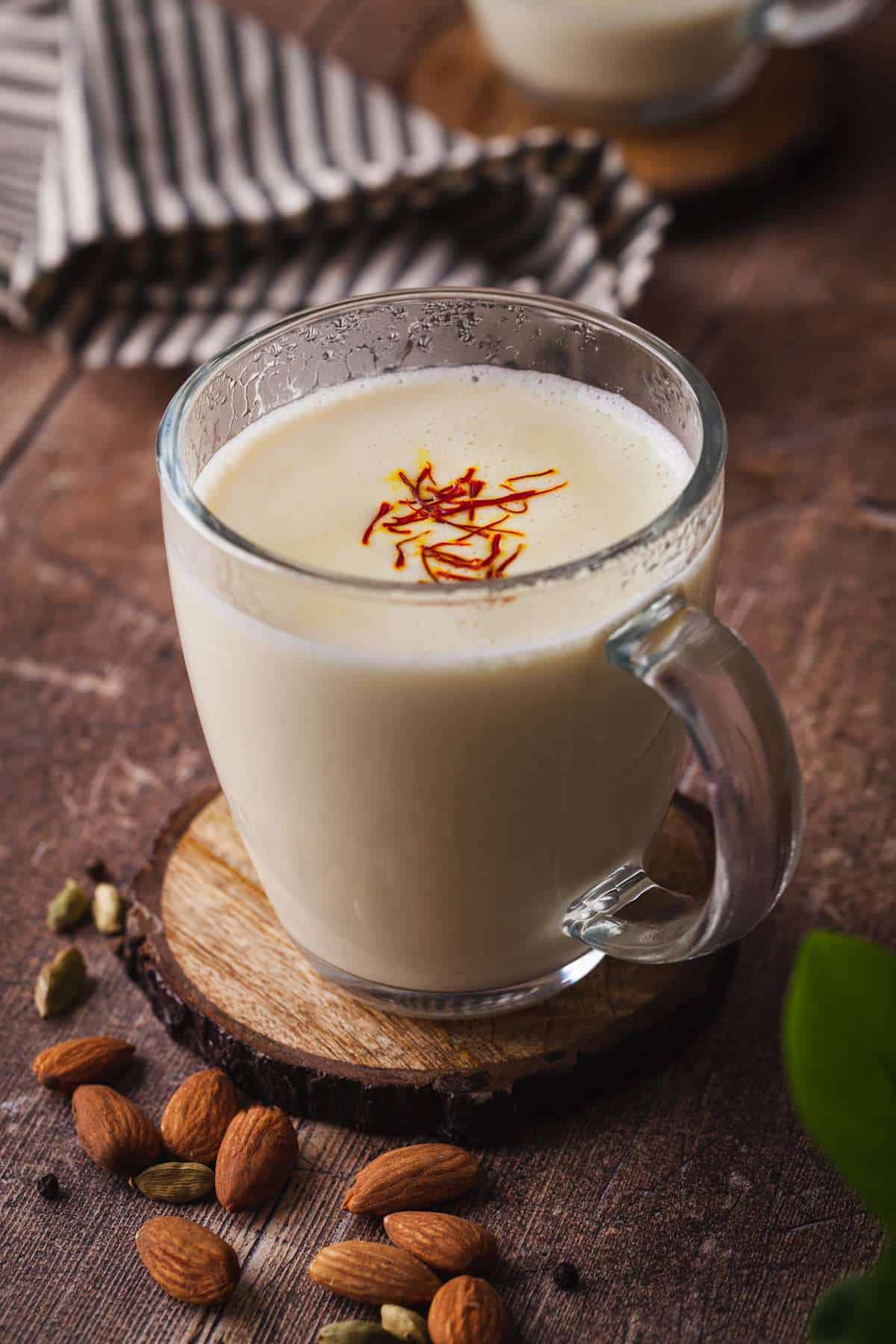 Badam Milk in a glass cup with a sprinkle of saffron. 