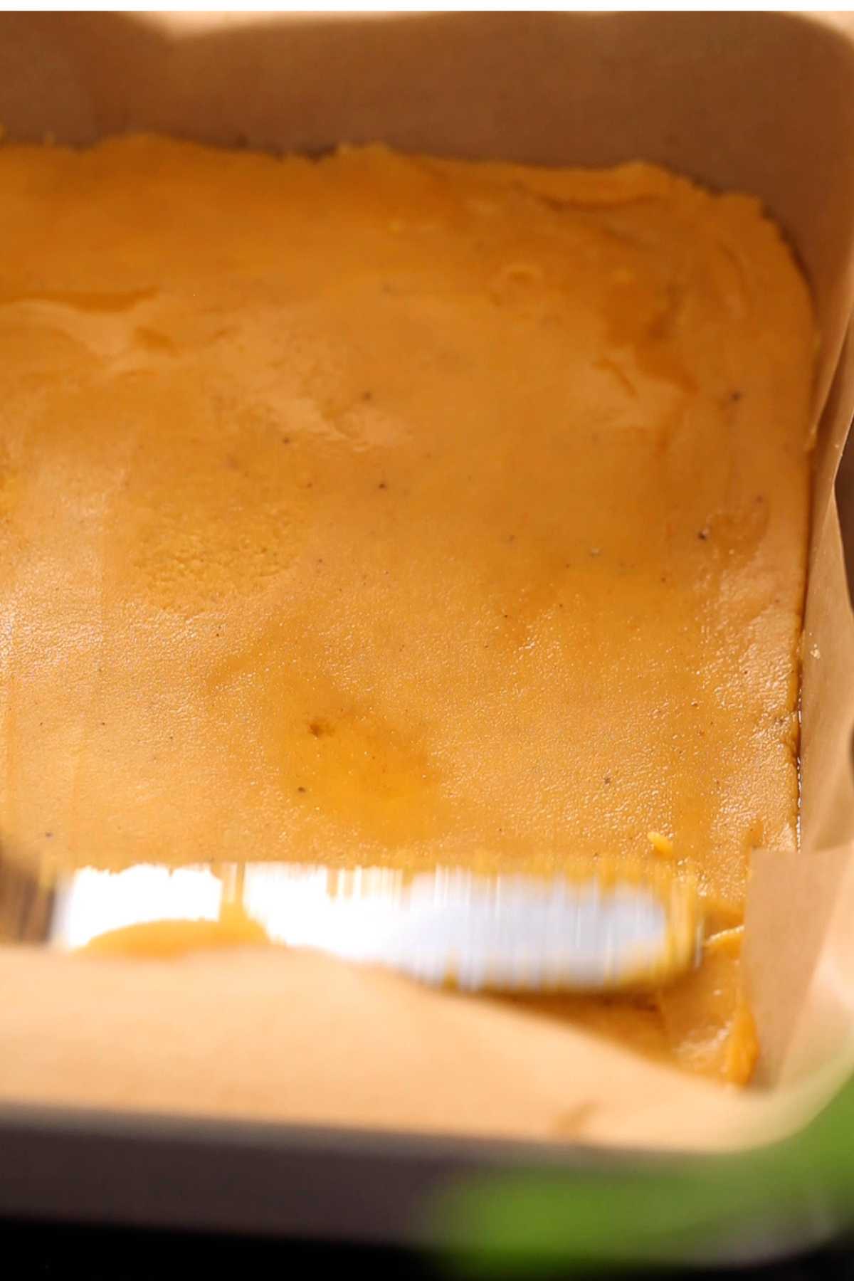 Spread the barfi mixture in a tray and smoothen with spatula. 