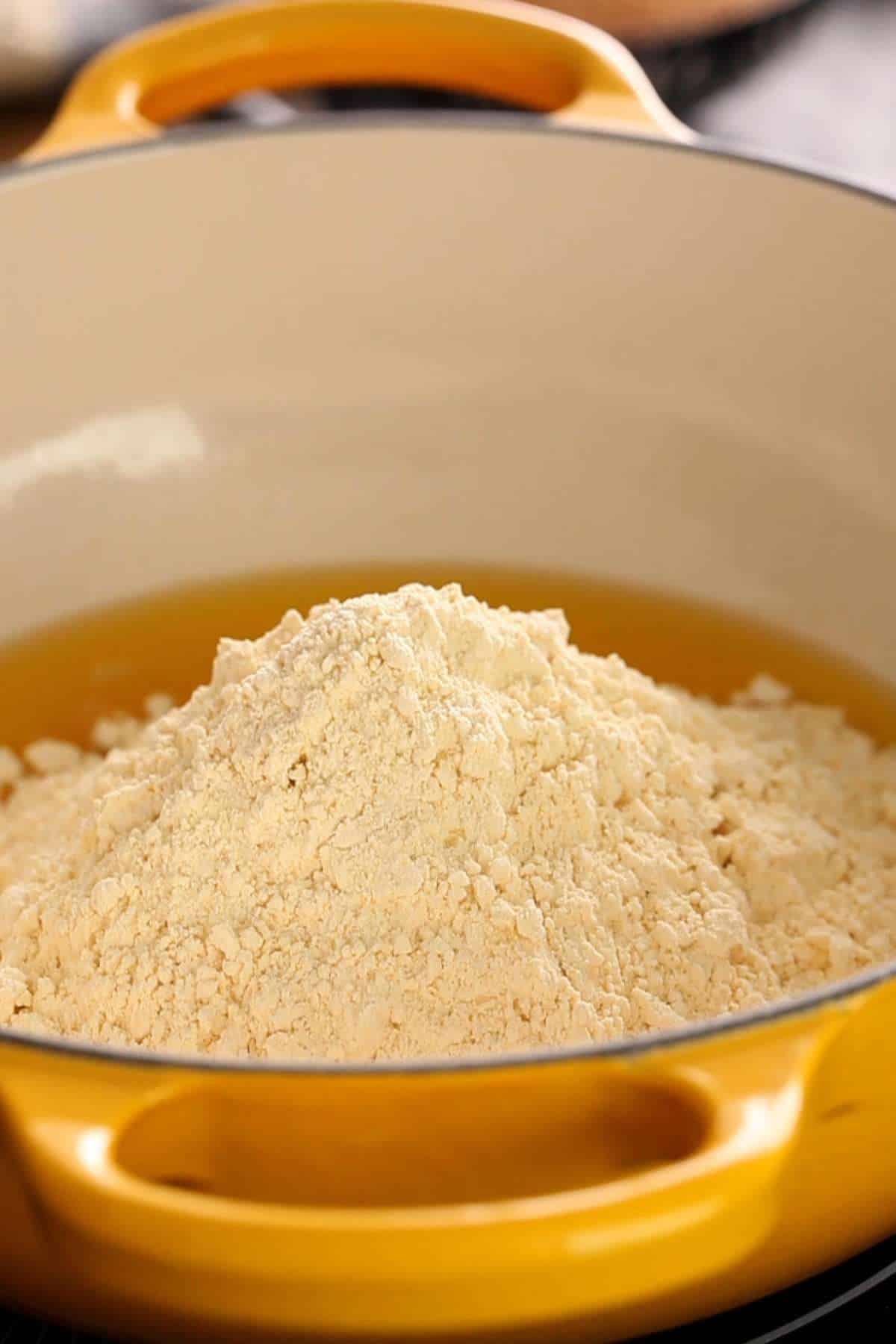 Add besan and ghee to a wide heavy pan.