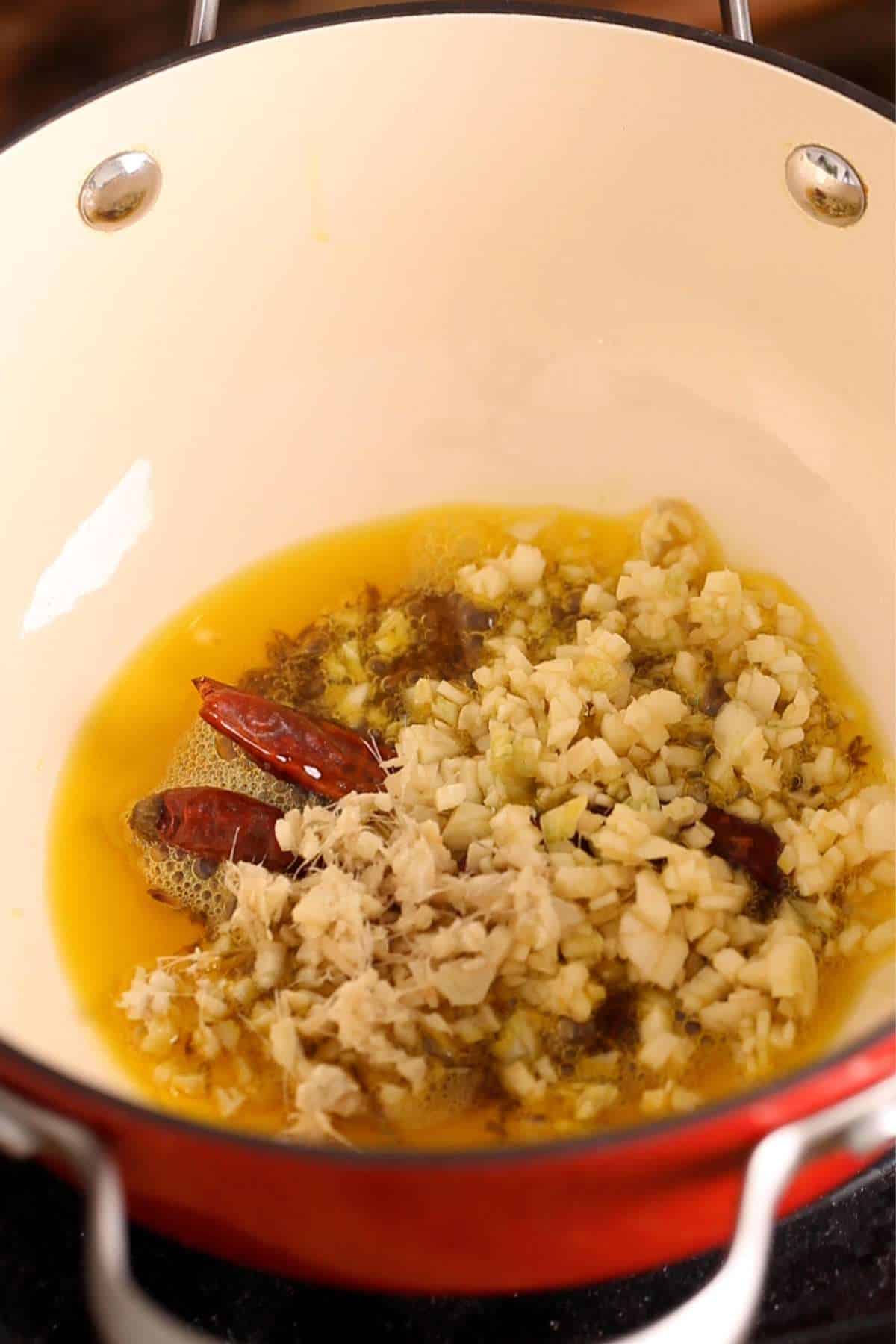 Add chopped ginger, garlic, hing & dried chilli