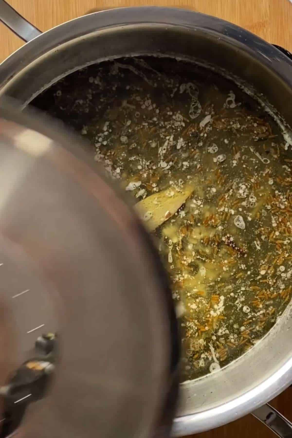 Cover and cook the khichdi until lentils and rice are soft.