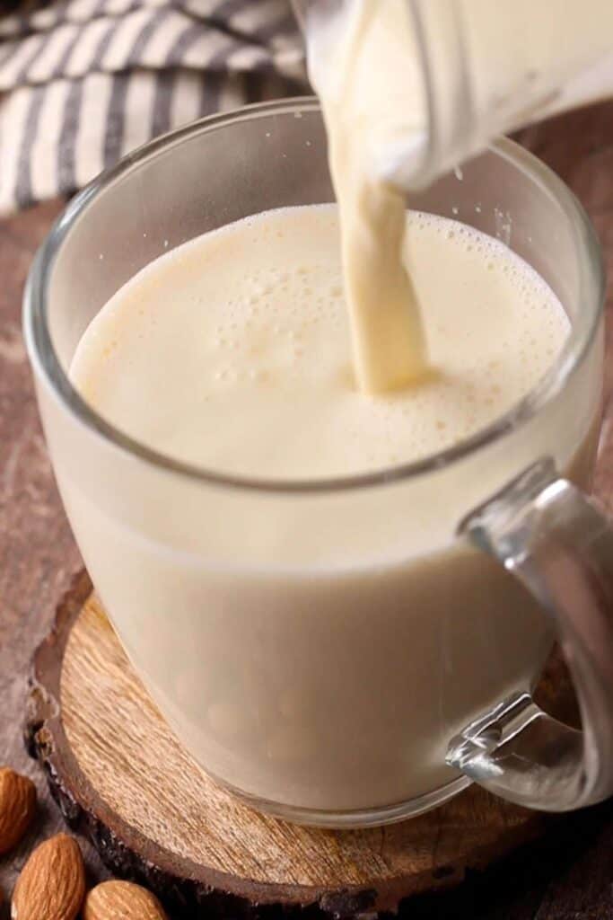 Badam Doodh poured in a glass cup.
