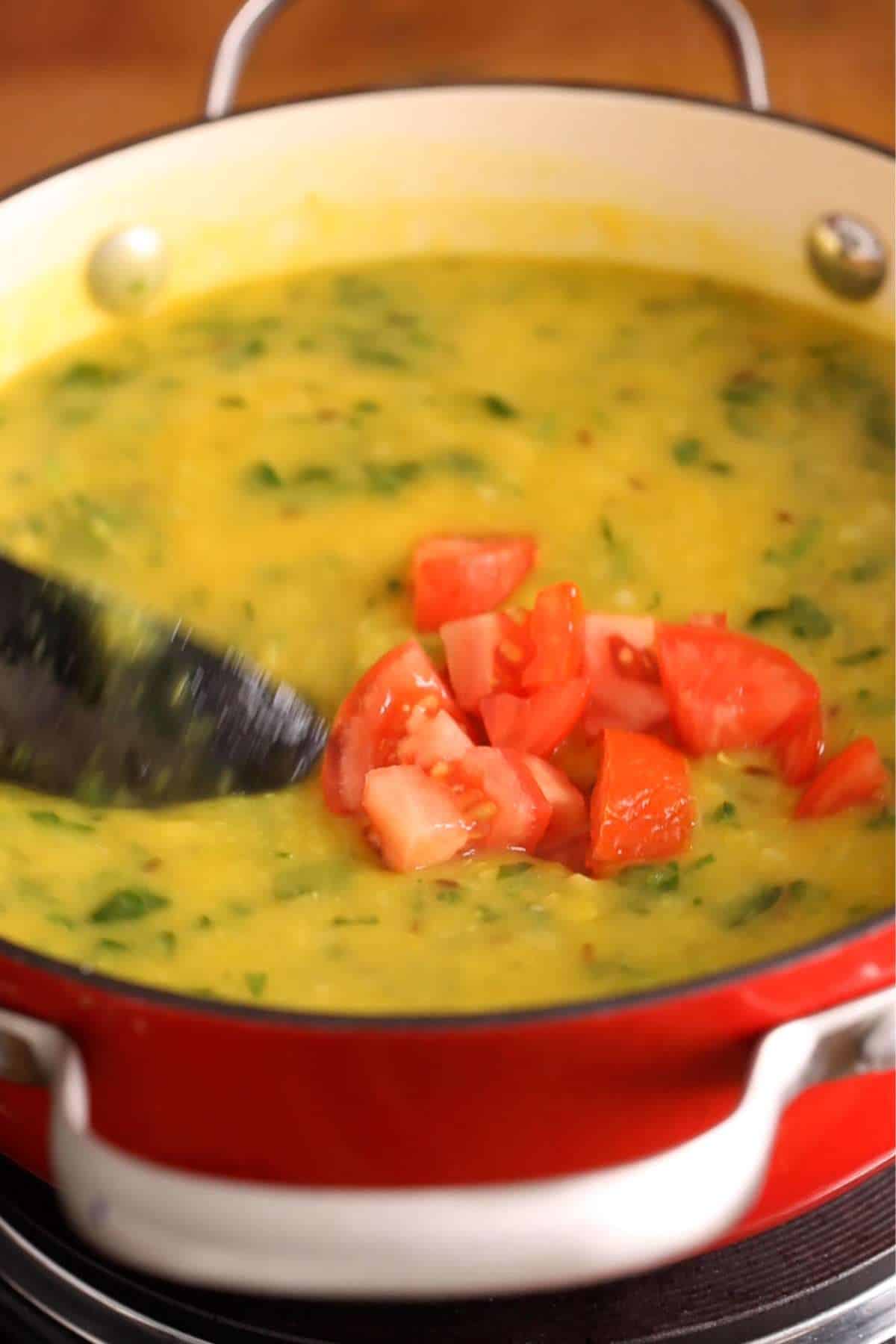 Add tomatoes to lentils.