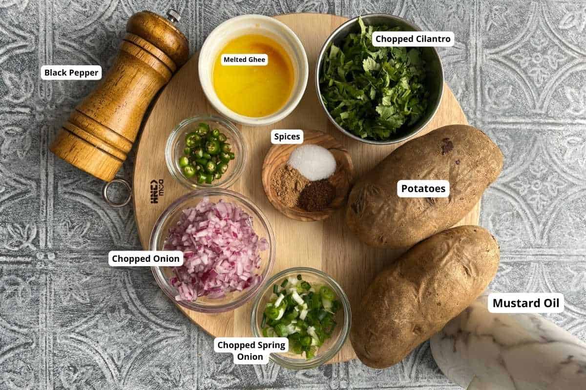 Ingredients needed to make indian style mashed potatoes called aloo bharta.