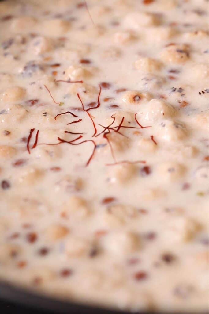 Garnishing Makhane Ki Kheer with saffron