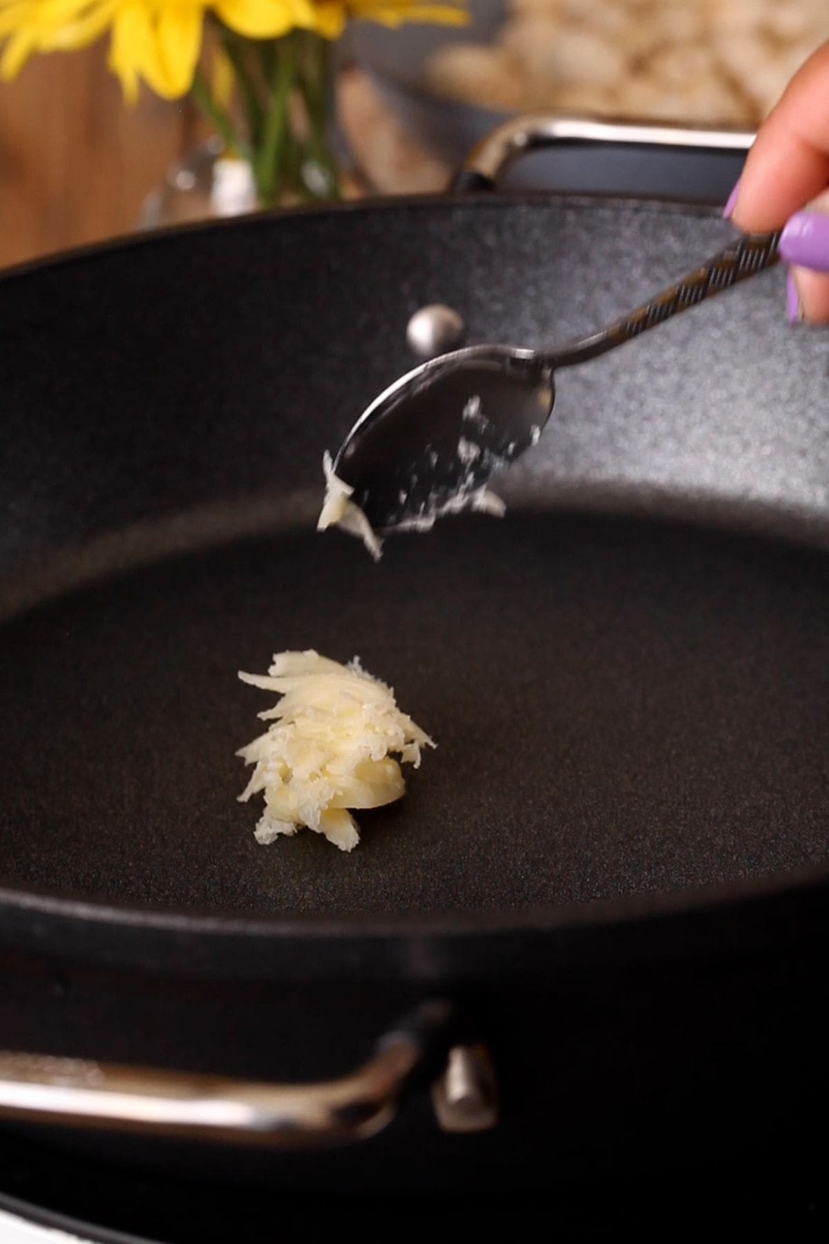Ghee is added to a large black pan.