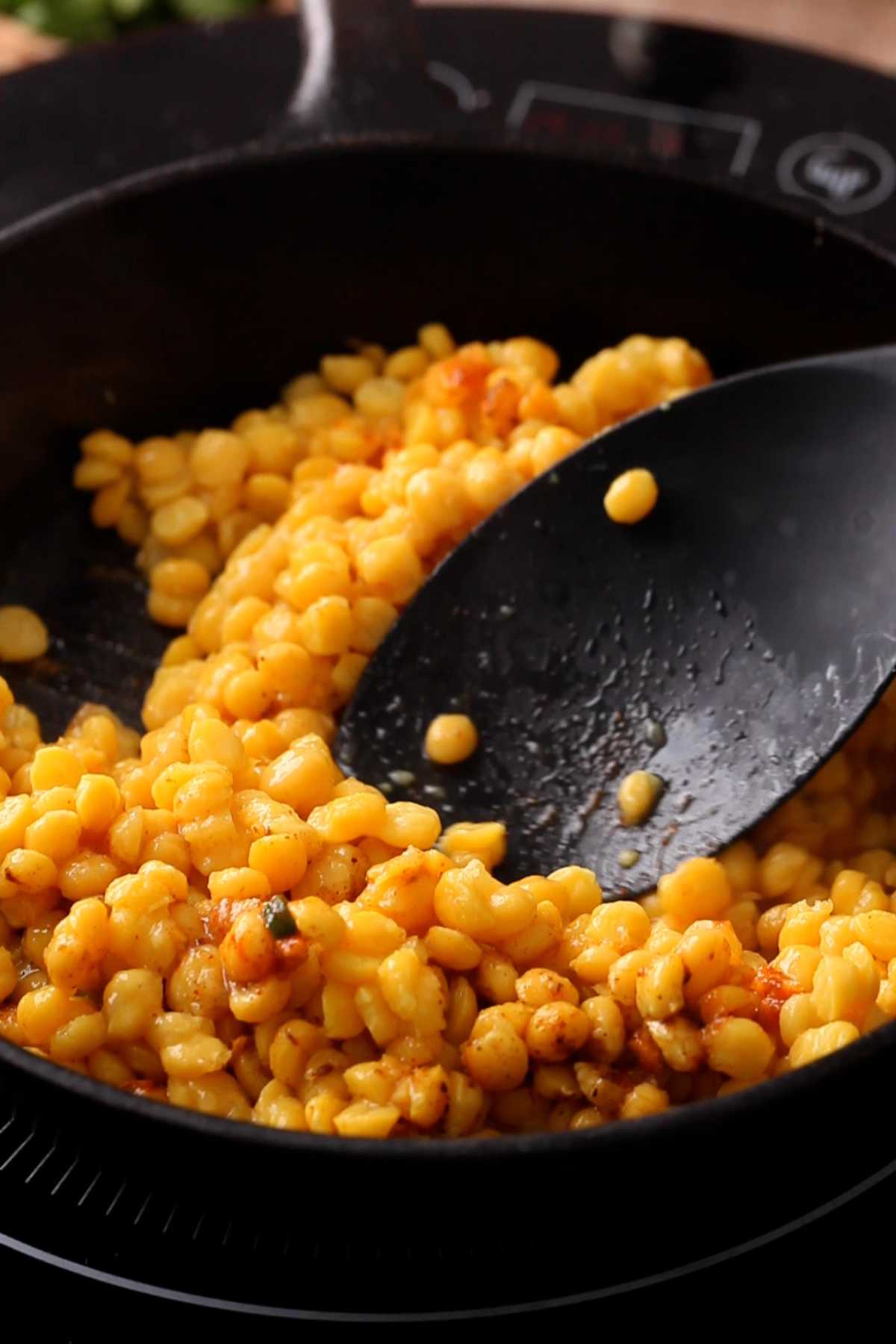 Smashing the lentils while they cook.