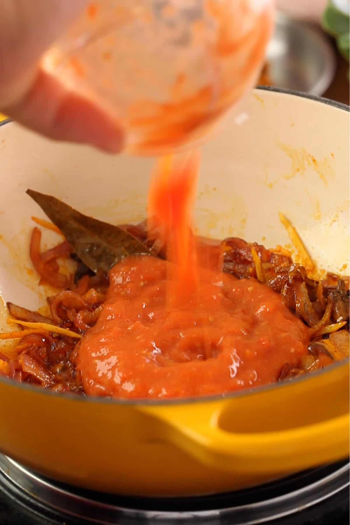 Tomatoes are added to the onions.