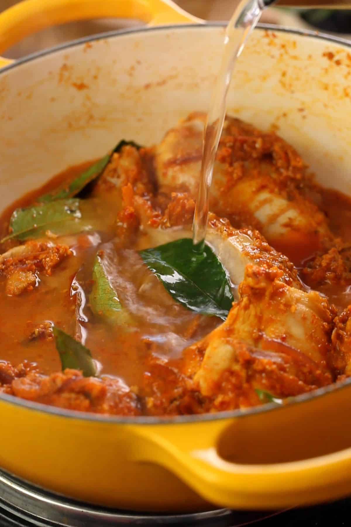 Hot water is added to the chicken curry.