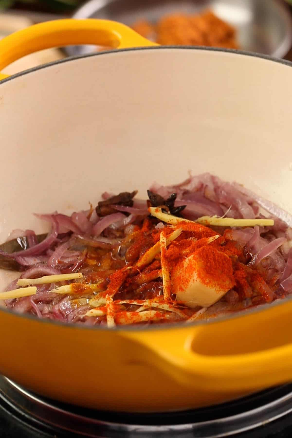 Ginger garlic and red chili powder is added to browned onions.