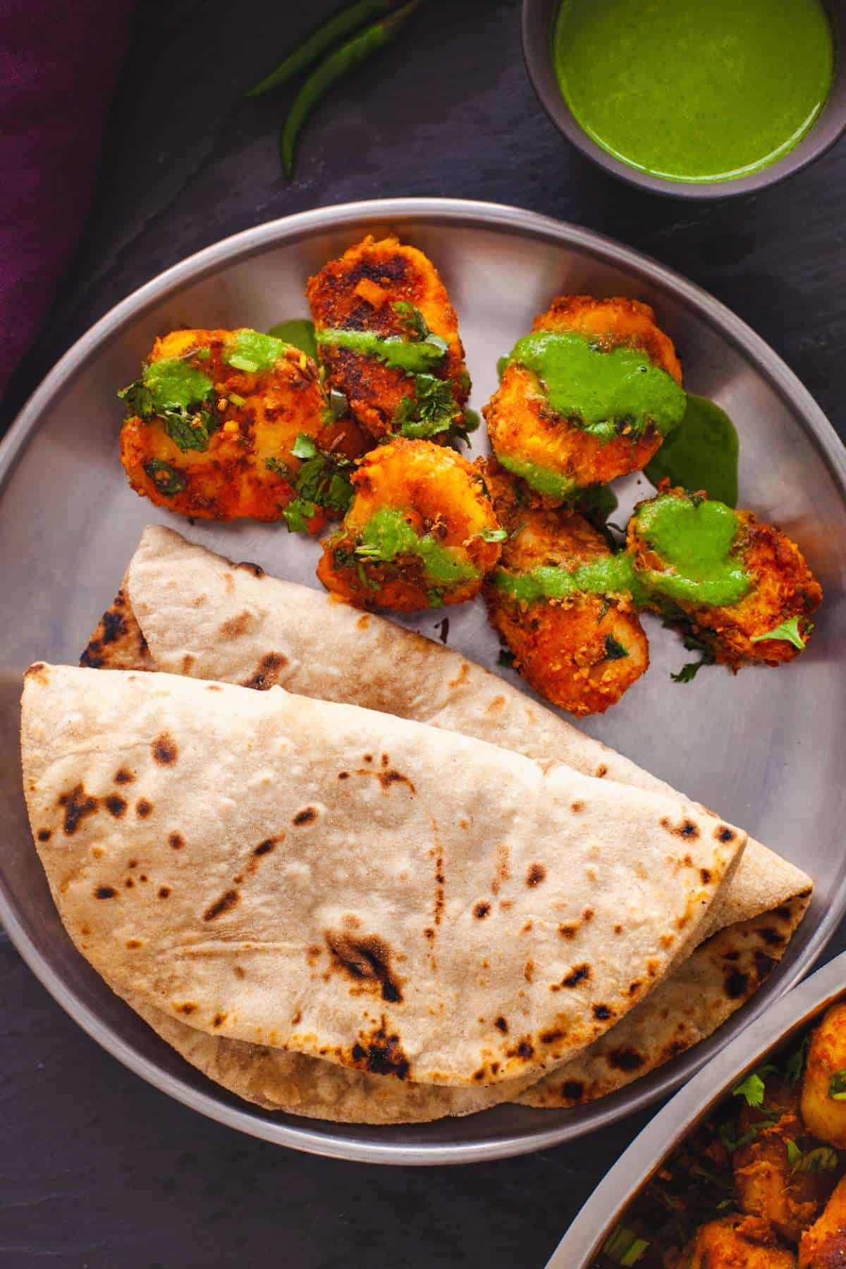 Taro root fry served with rotis and green chutney.
