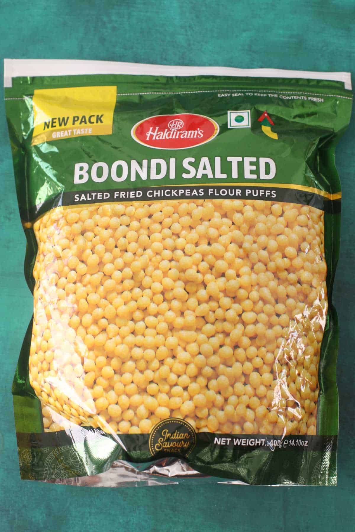 Packet of Boondi placed on a green background. 