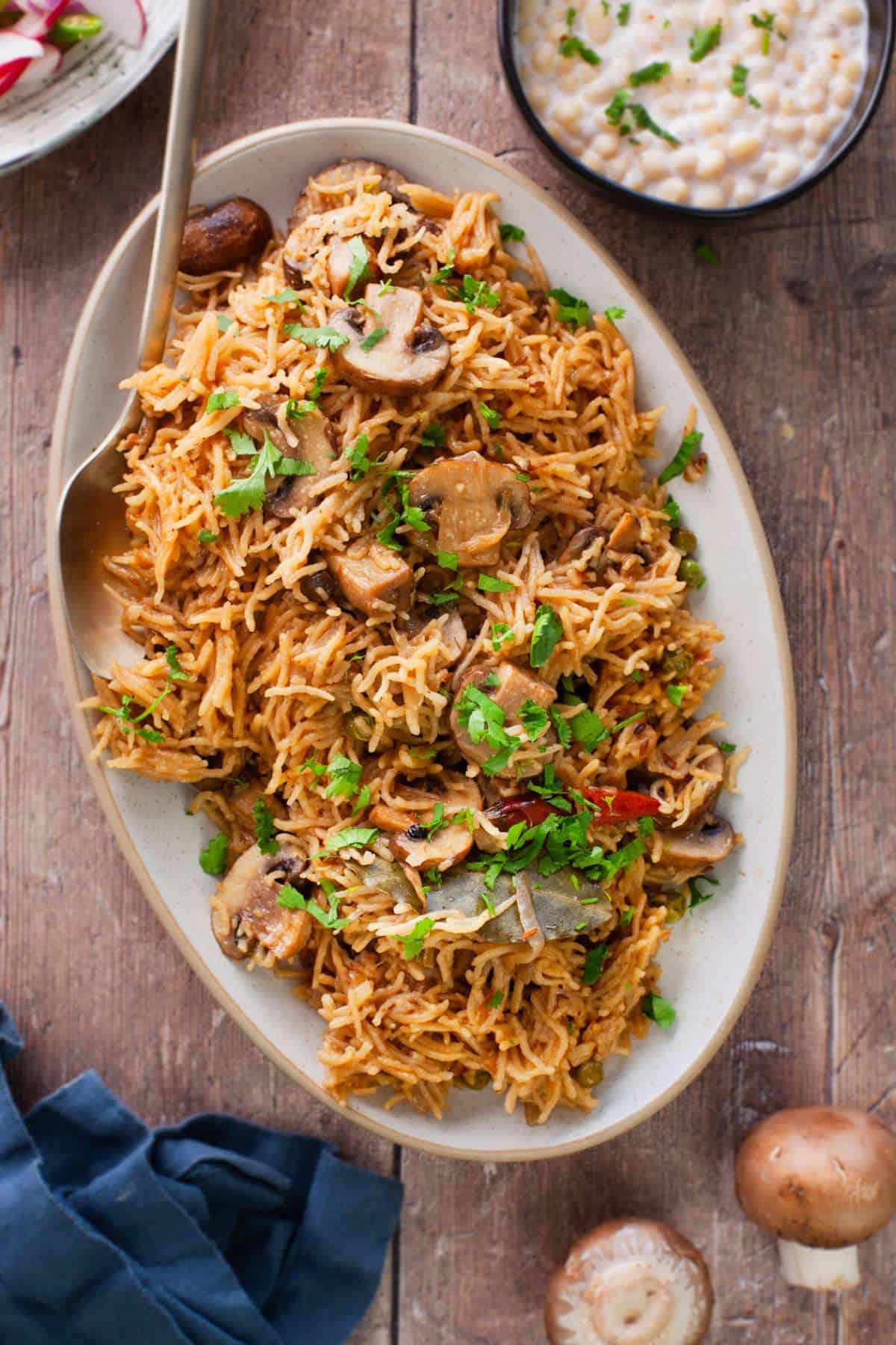 Mushroom pulao served on a oval platter.