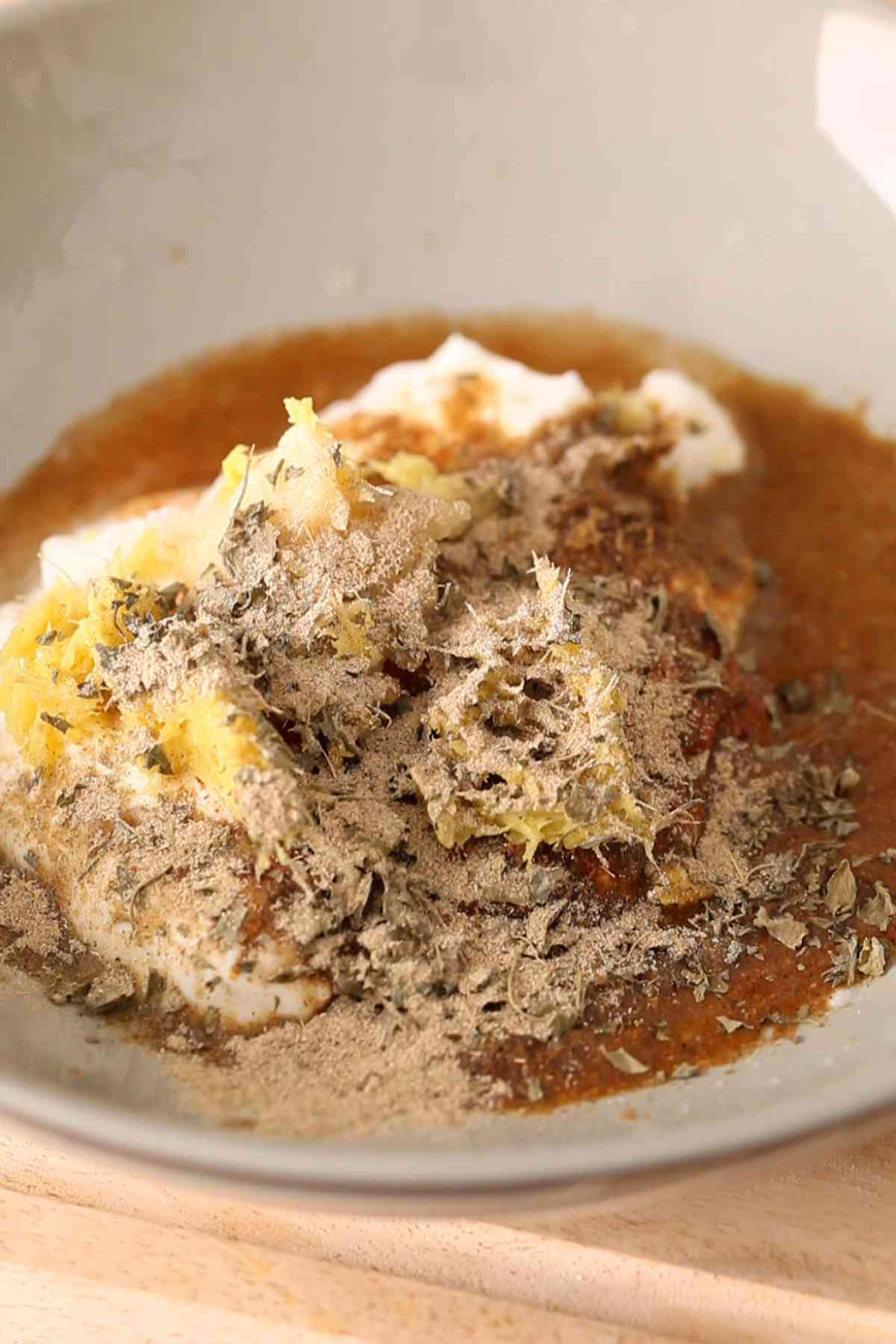 Marinade ingredients for tikka in a grey bowl. 