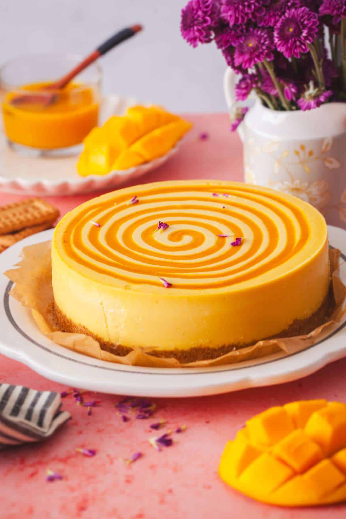 Baked Mango cheesecake placed on a pink background. 