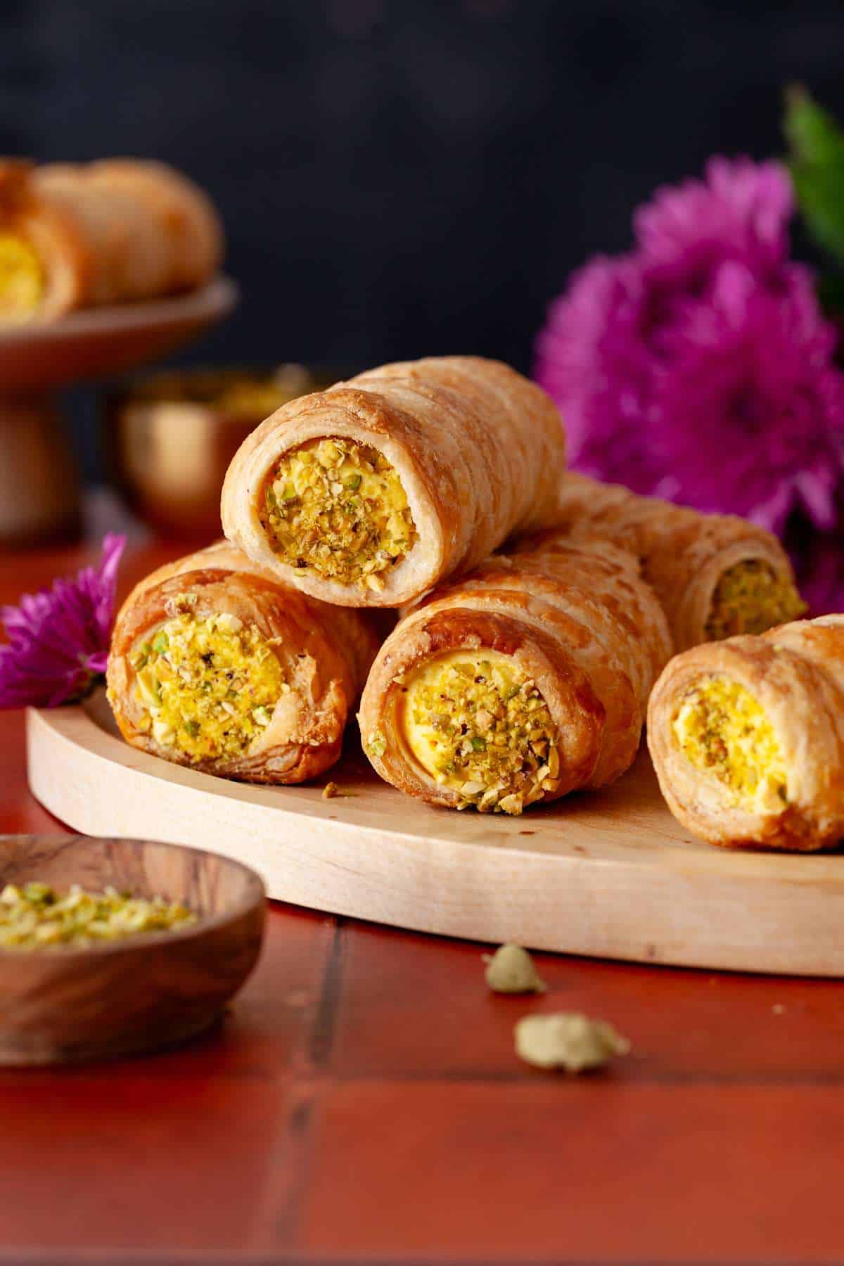 Pistachio Cream Roll Stack on a bamboo plate.