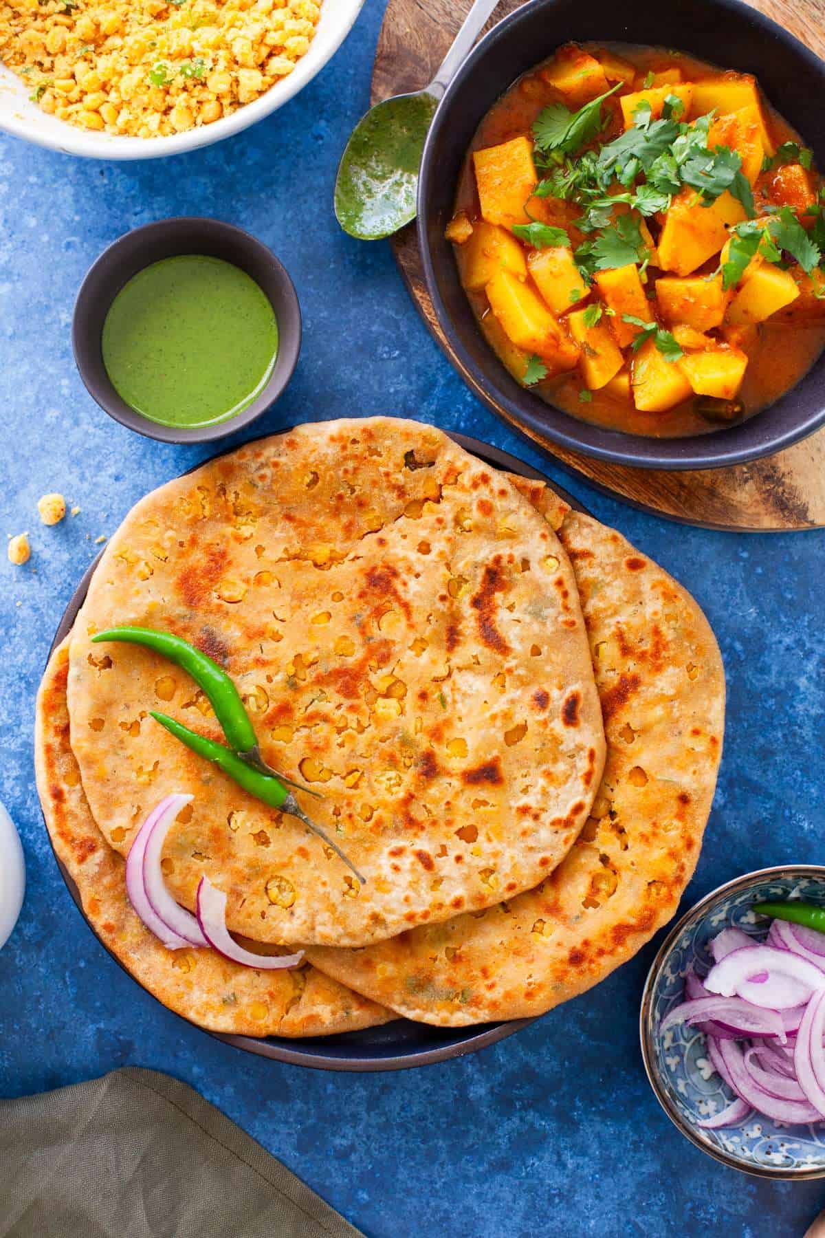 Chana Dal Paratha in a plate with potato curry. 
