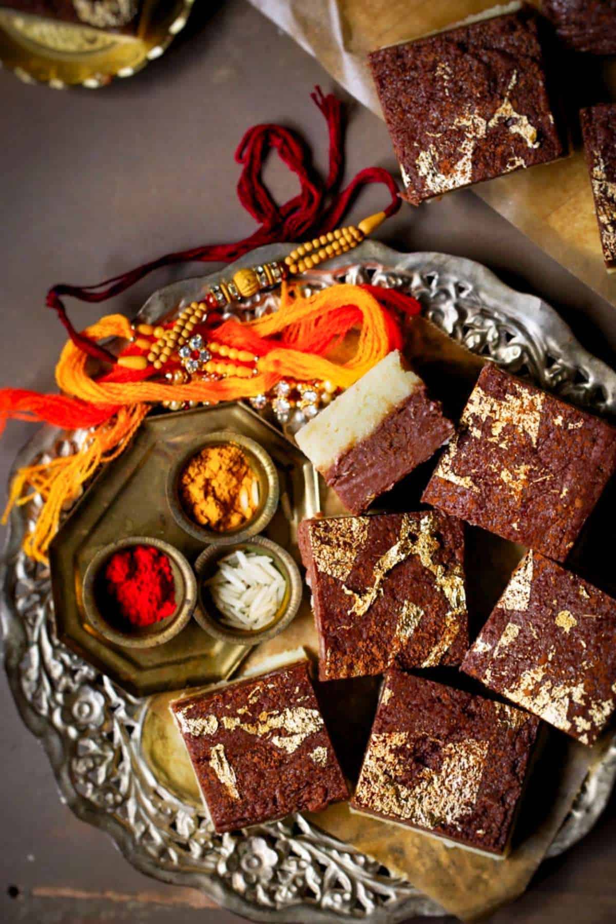 Chocolate burfi pieces in a silver tray.