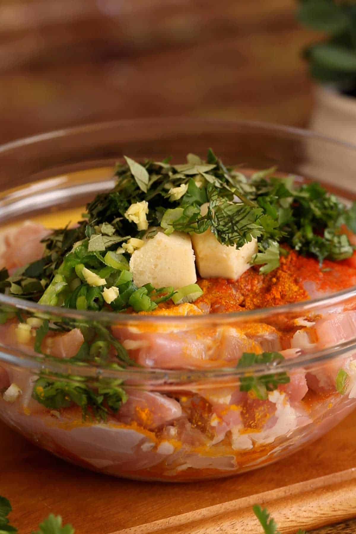 Mix in the fresh herbs and ginger garlic to the chicken.