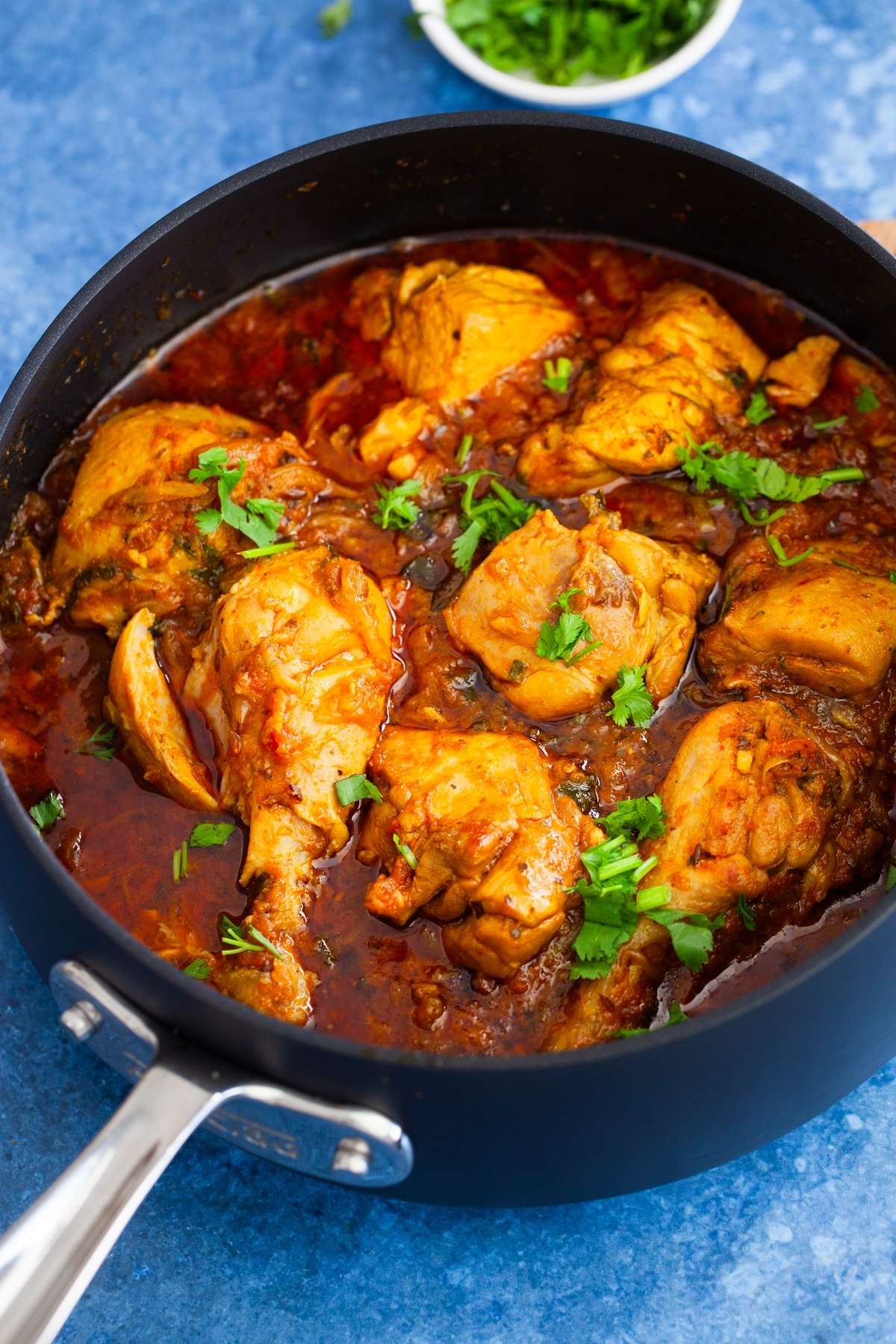 Close up shot of murgh masala in a black cooking pot.