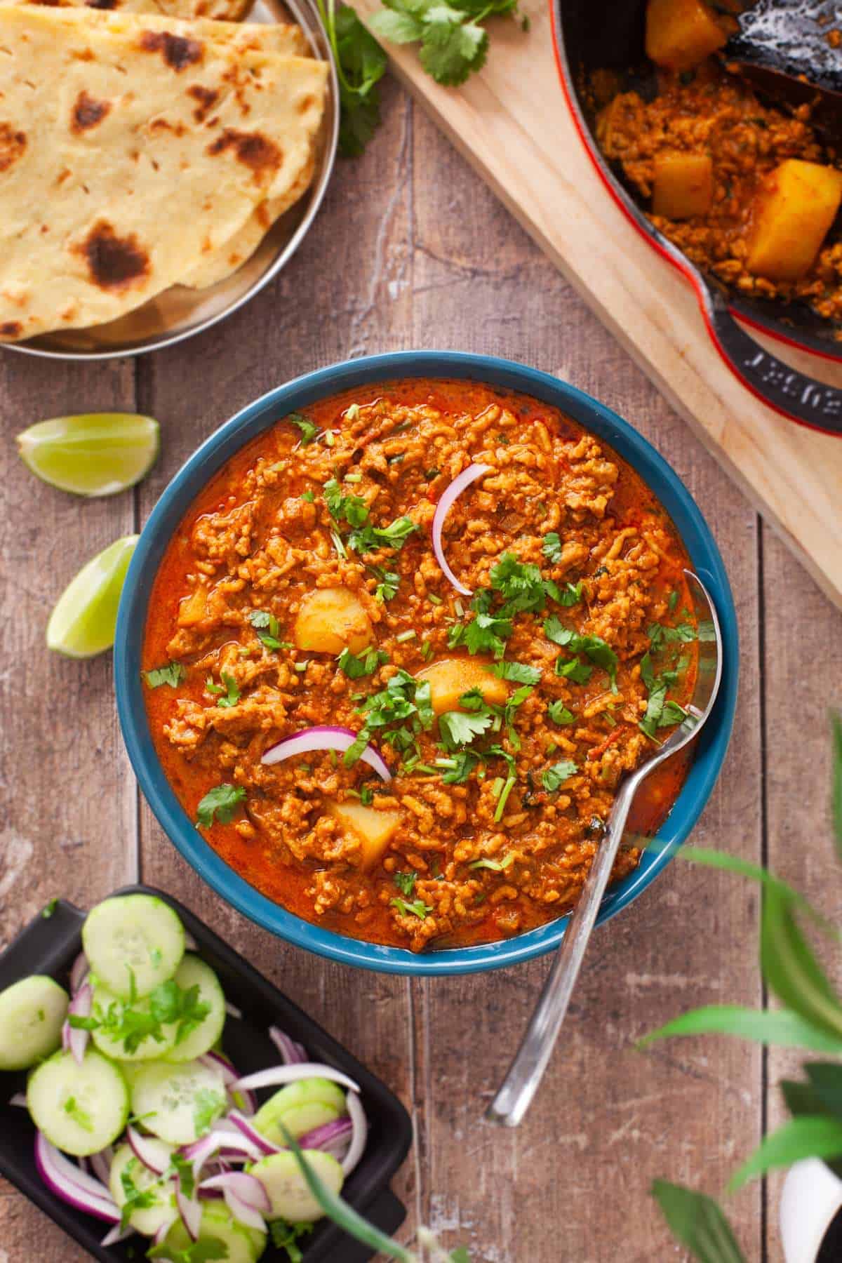 Chicken Keema in a blue bowl garnished with cilantro. 