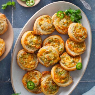 Jalapeno Pinwheels palce in an oval platter with chutney.
