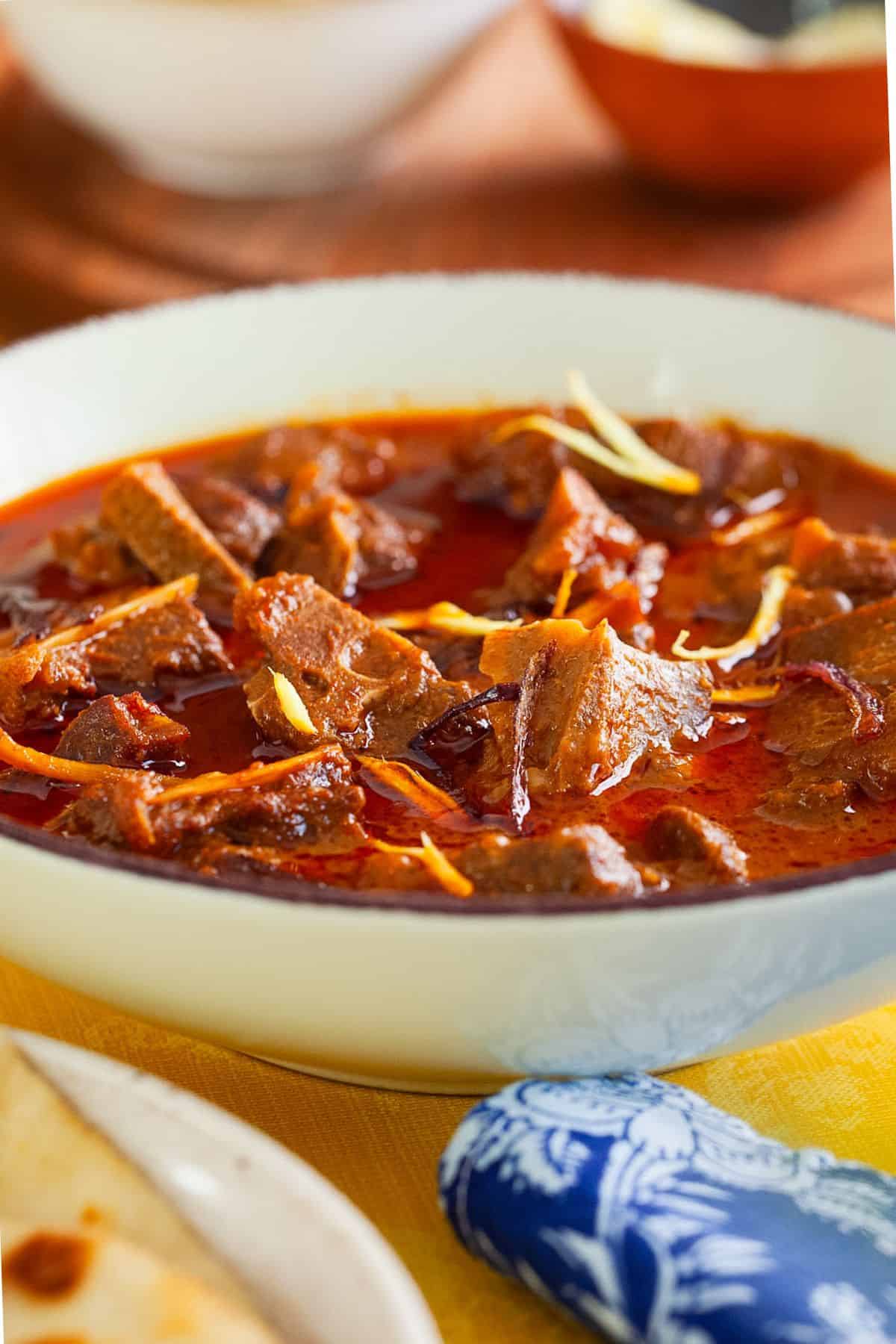 Side closeup of indian style mutton korma.