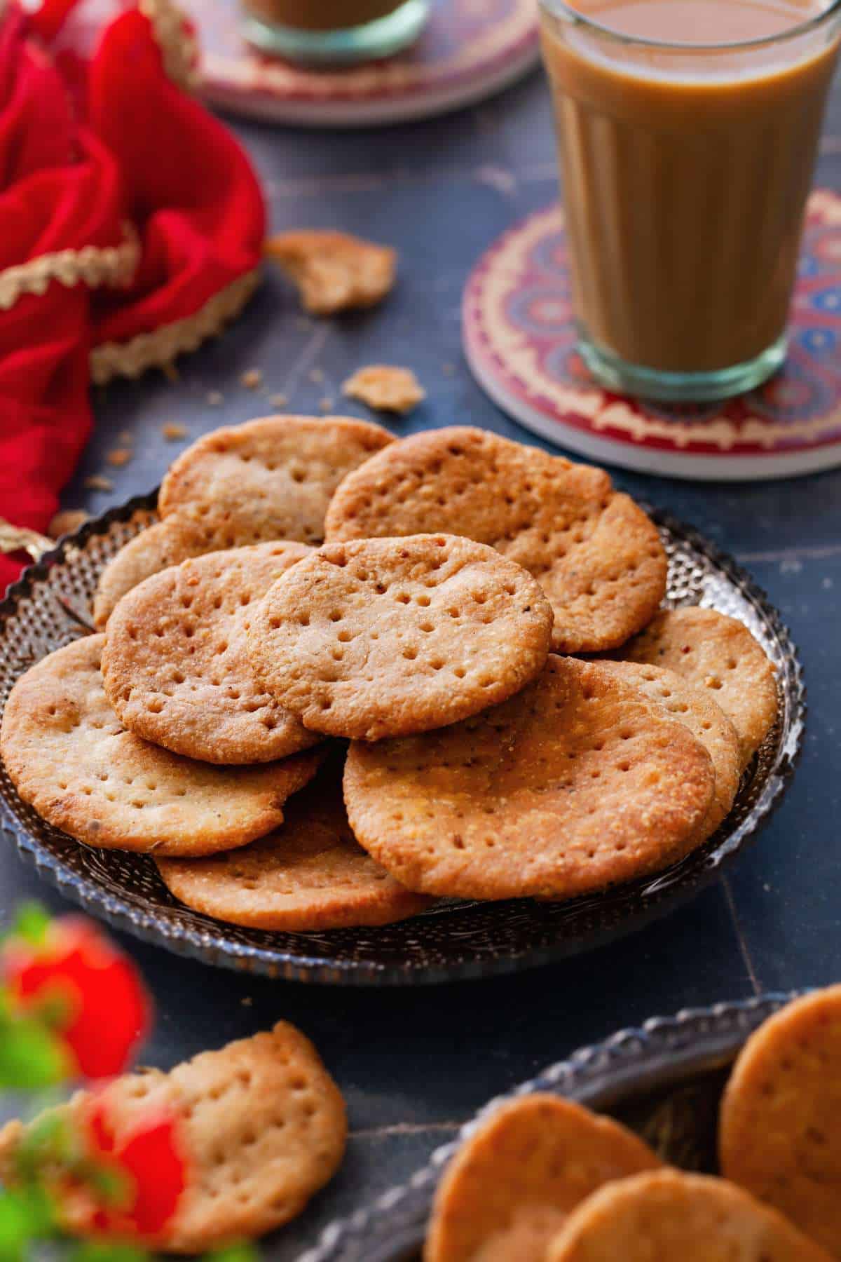 Side view of indian savory crackers served with tea.