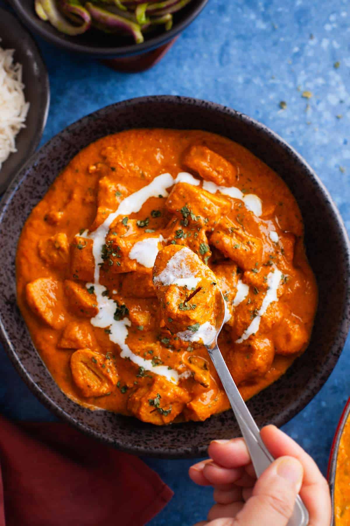 Close up of makhani soya sauce in a spoon.