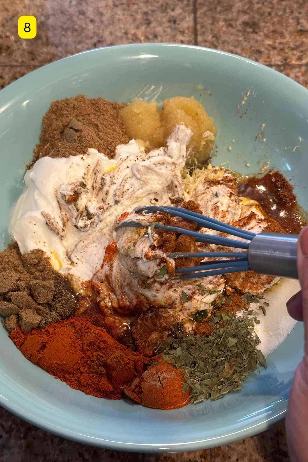 Whisking tandoori marinade.