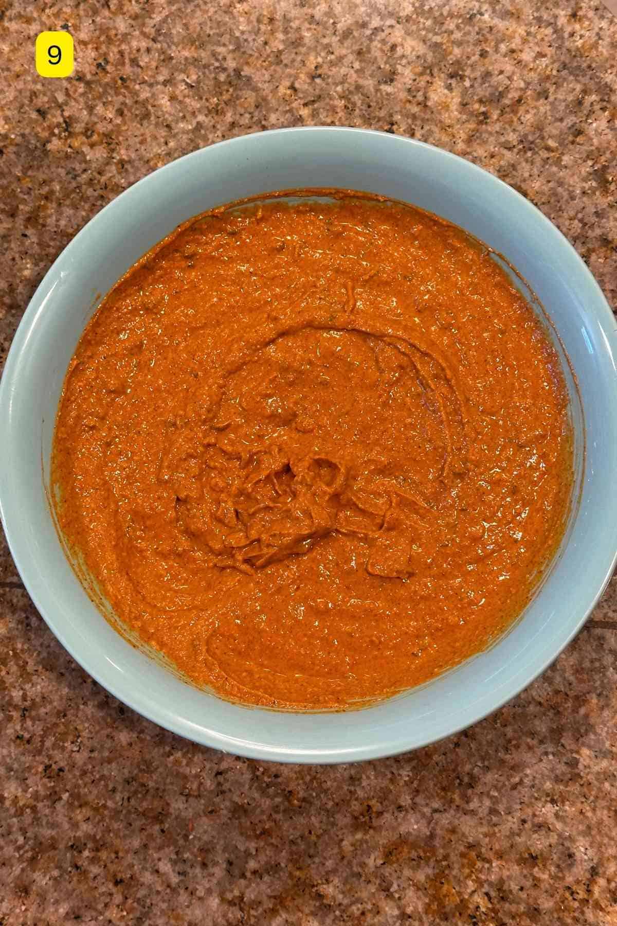 Tandoori chicken marinade in a blue bowl.