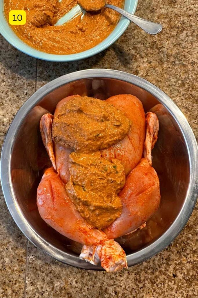 Marinating whole chicken with tandoori marinade.