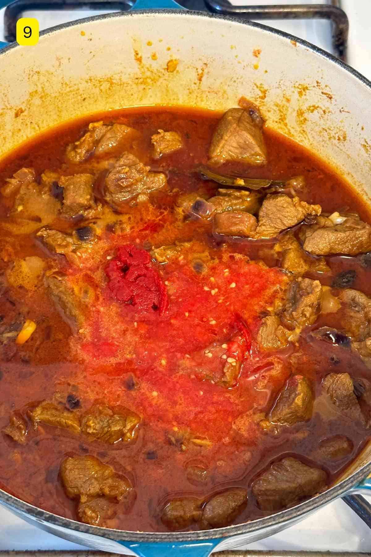 Adding tomatoes to lamb.