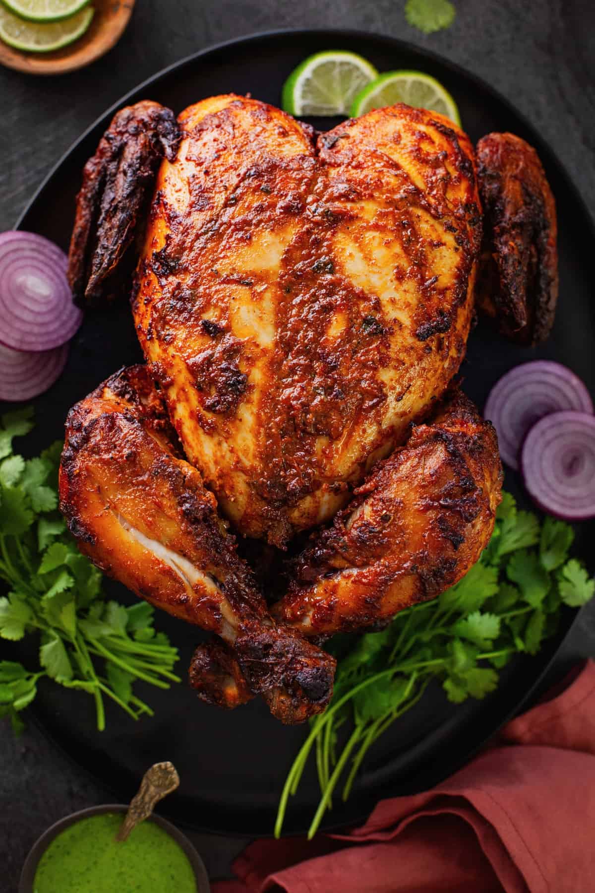 Airfryer Whole Tandoori Chicken served on a black platter.