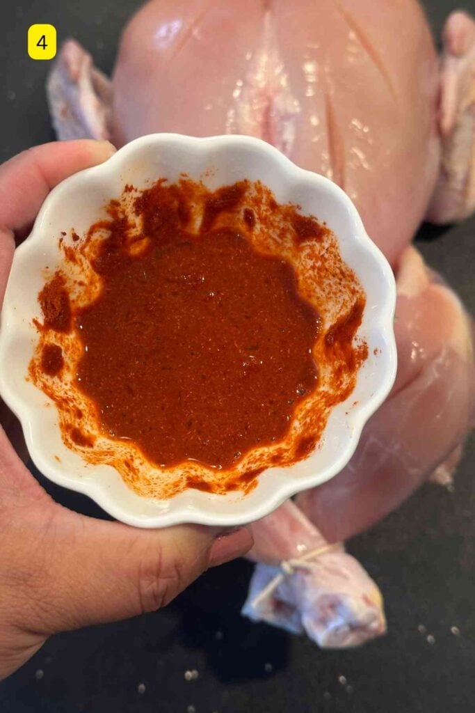 A small wjite bowl with lemon marinade for chicken.