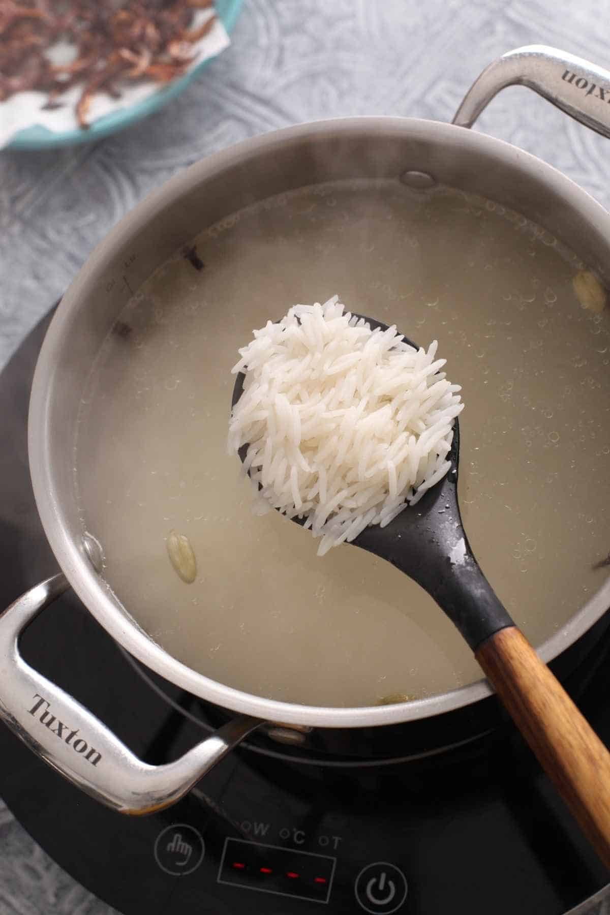 Cooked biryani rice ready for layering.